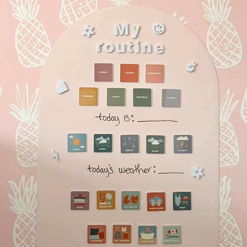 Wall calendar with pineapple designs and weather icons on a pink background