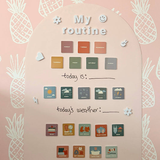Wall calendar with pineapple designs and weather icons on a pink background
