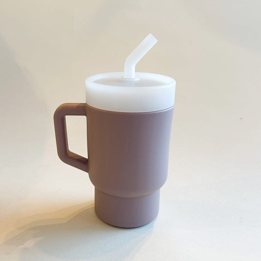 A lightweight 9oz toddler tumbler in soft, premium silicone, designed with a handle for easy grip and portability. The tumbler features a leak-resistant straw with a soft silicone tip, making it perfect for independent sipping. Available in playful colors for kids, it combines functionality with fun for little explorers. Lilac rose for little girls.