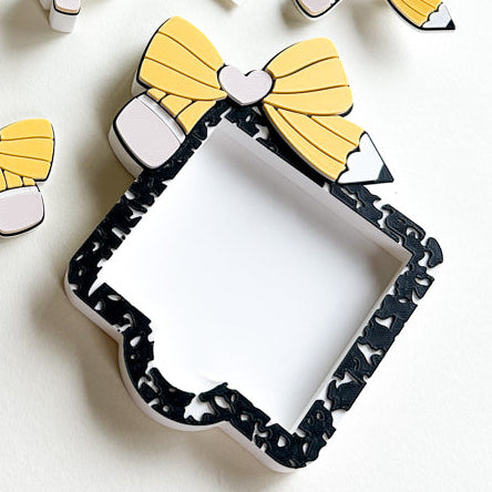 Collection of decorative items with yellow bows on a light background