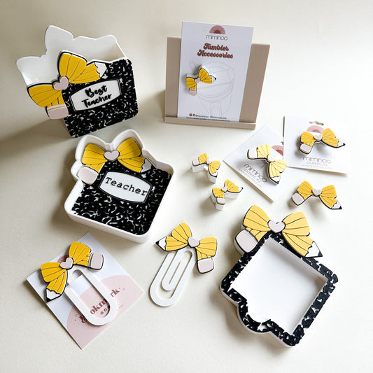 Collection of decorative items with yellow bows on a light background